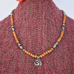 23  1/2" natural Tulasi with Om pendant and dark teal blue beads 40.00